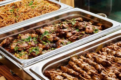 trays of food at a buffet